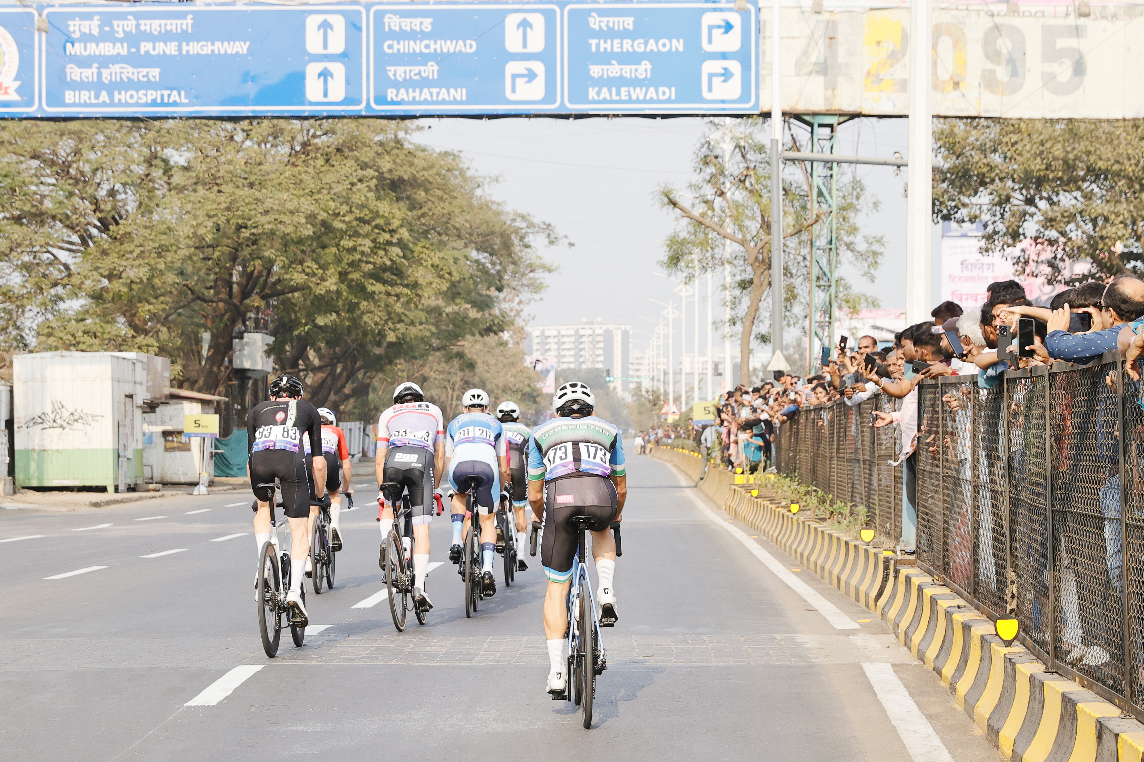 Riders Zooming past the country side during stage one of the Pune Grand Tour 2026 held in the City of Pune on the 20th January 2026.  The Pune Grand Tour marks India’s first entry into the global professional cycling calendar.   Owing to its UCI classification the PGT2026 will offer riders the opportunity to earn valuable ranking points that count toward qualification for the LA 2028 Summer Olympics.Photo by s Saikat Das / Sportzpics / PGT