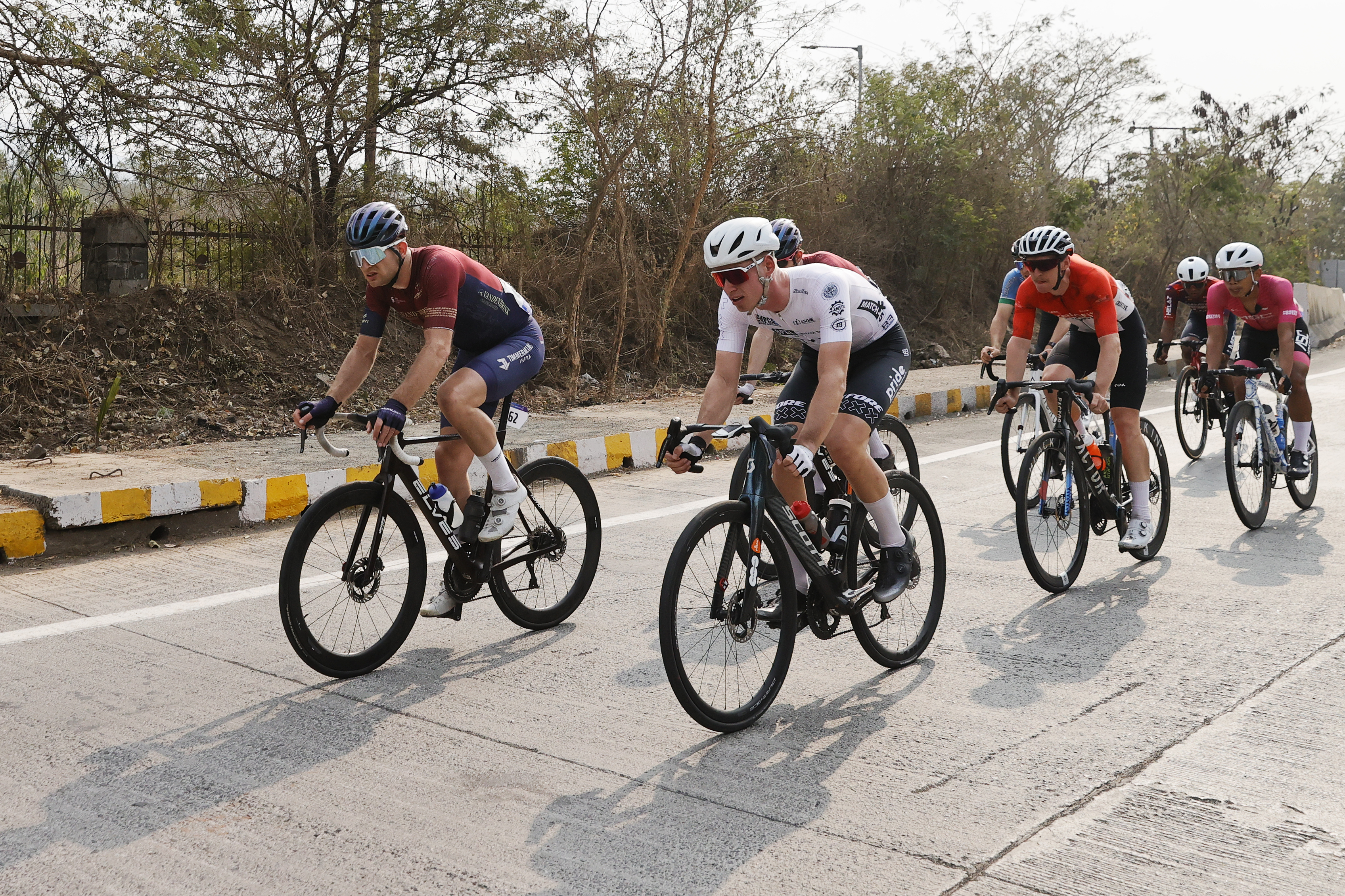 Riders zoom past the country side during stage two of the Bajaj Pune Grand Tour 2026 held in the City of Pune on the 21st January 2026.  The Pune Grand Tour marks India’s first entry into the global professional cycling calendar.   Owing to its UCI classification the PGT2026 will offer riders the opportunity to earn valuable ranking points that count toward qualification for the LA 2028 Summer Olympics.Photo by s Saikat Das /Sportzpics / PGT 2026