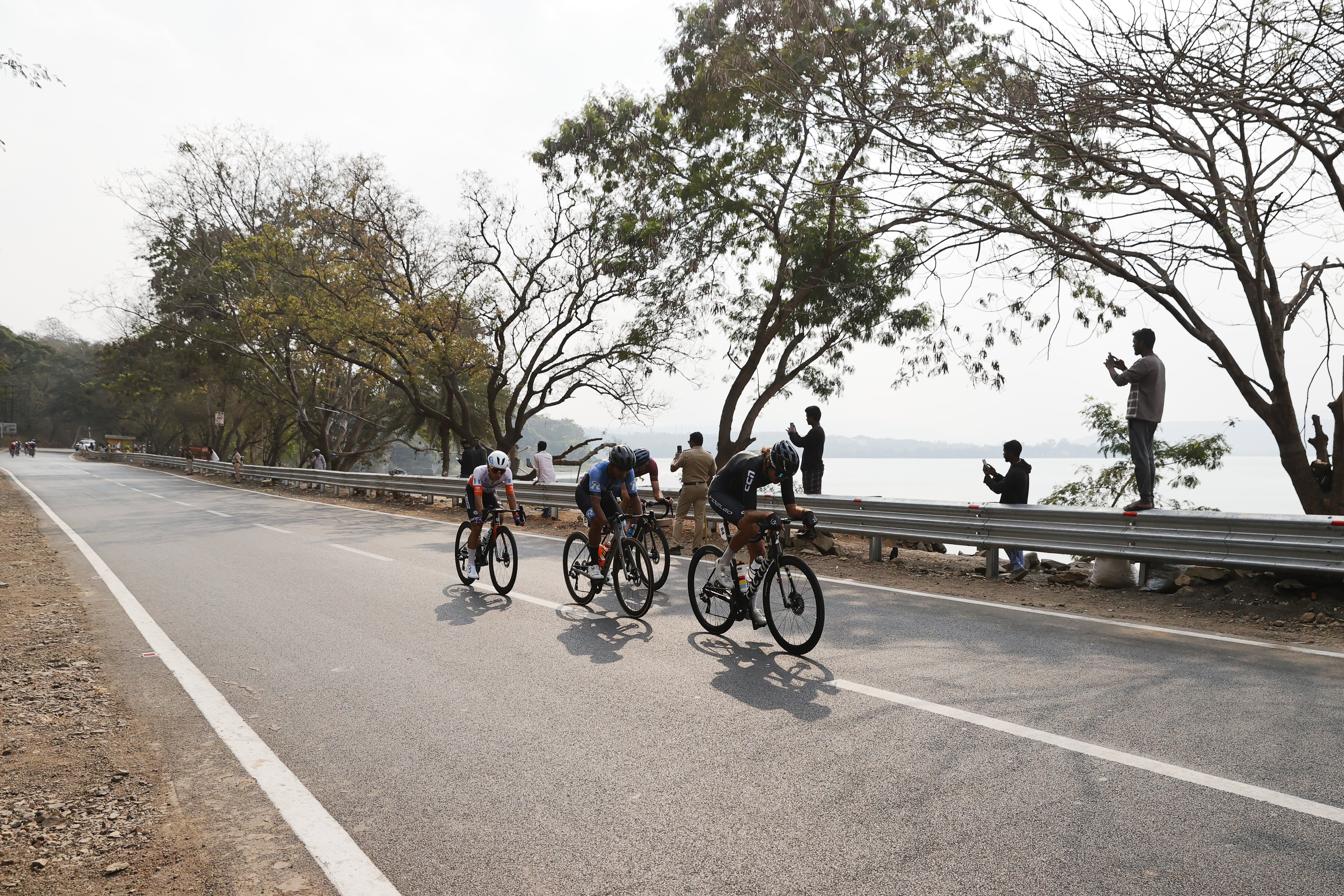 Riders zoom past the country side during stage two of the Bajaj Pune Grand Tour 2026 held in the City of Pune on the 21st January 2026.  The Pune Grand Tour marks India’s first entry into the global professional cycling calendar.   Owing to its UCI classification the PGT2026 will offer riders the opportunity to earn valuable ranking points that count toward qualification for the LA 2028 Summer Olympics.Photo by s Saikat Das /Sportzpics / PGT 2026