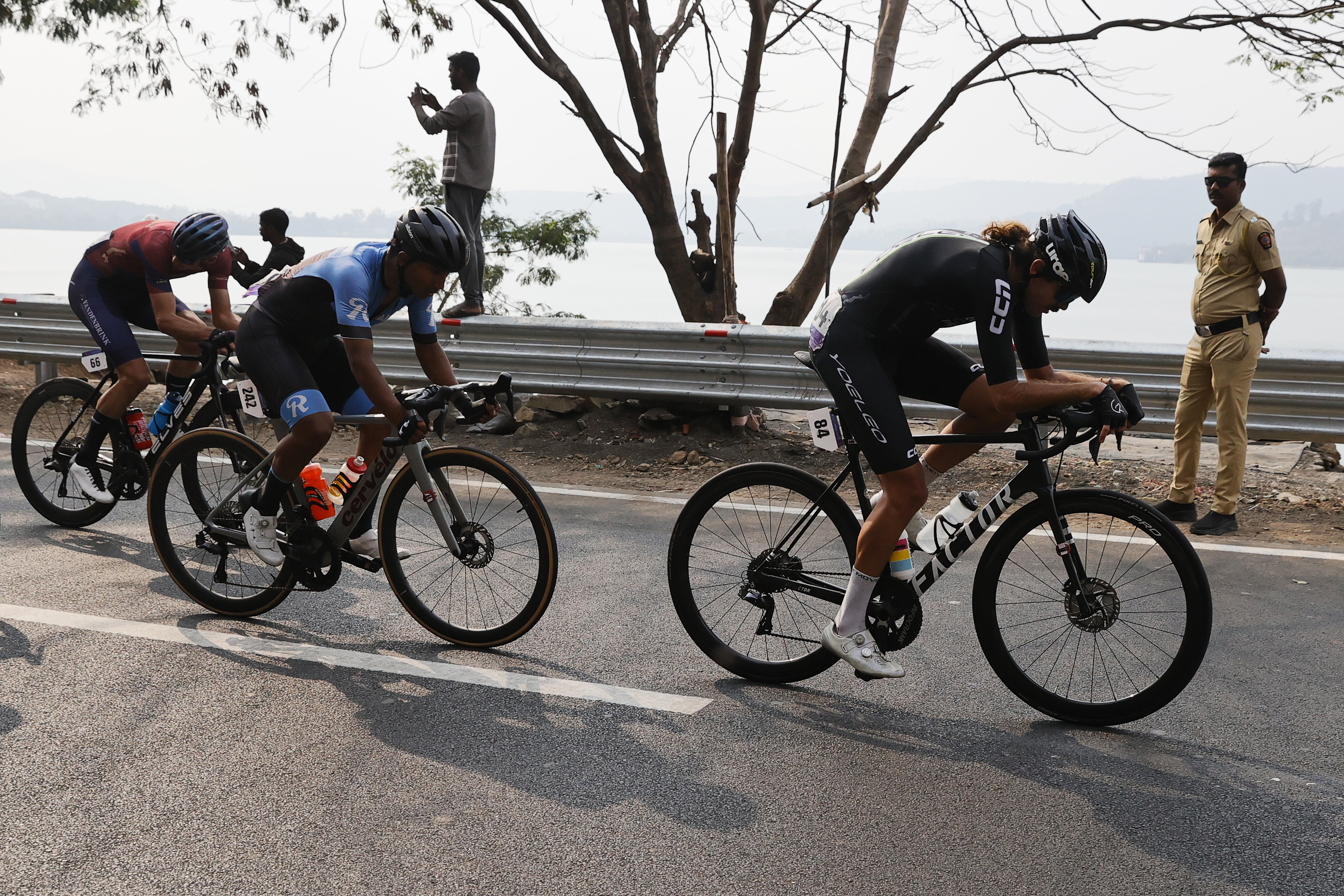 Riders zoom past the country side during stage two of the Bajaj Pune Grand Tour 2026 held in the City of Pune on the 21st January 2026.  The Pune Grand Tour marks India’s first entry into the global professional cycling calendar.   Owing to its UCI classification the PGT2026 will offer riders the opportunity to earn valuable ranking points that count toward qualification for the LA 2028 Summer Olympics.Photo by s Saikat Das /Sportzpics / PGT 2026