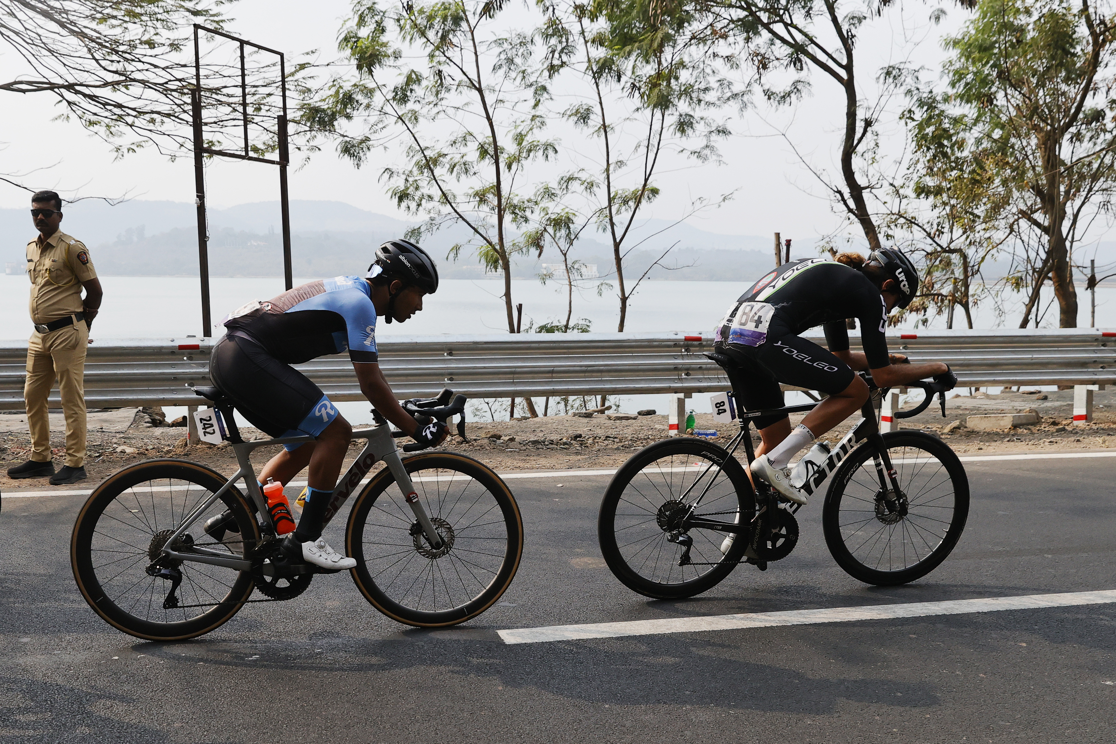 Riders zoom past the country side during stage two of the Bajaj Pune Grand Tour 2026 held in the City of Pune on the 21st January 2026.  The Pune Grand Tour marks India’s first entry into the global professional cycling calendar.   Owing to its UCI classification the PGT2026 will offer riders the opportunity to earn valuable ranking points that count toward qualification for the LA 2028 Summer Olympics.Photo by s Saikat Das /Sportzpics / PGT 2026