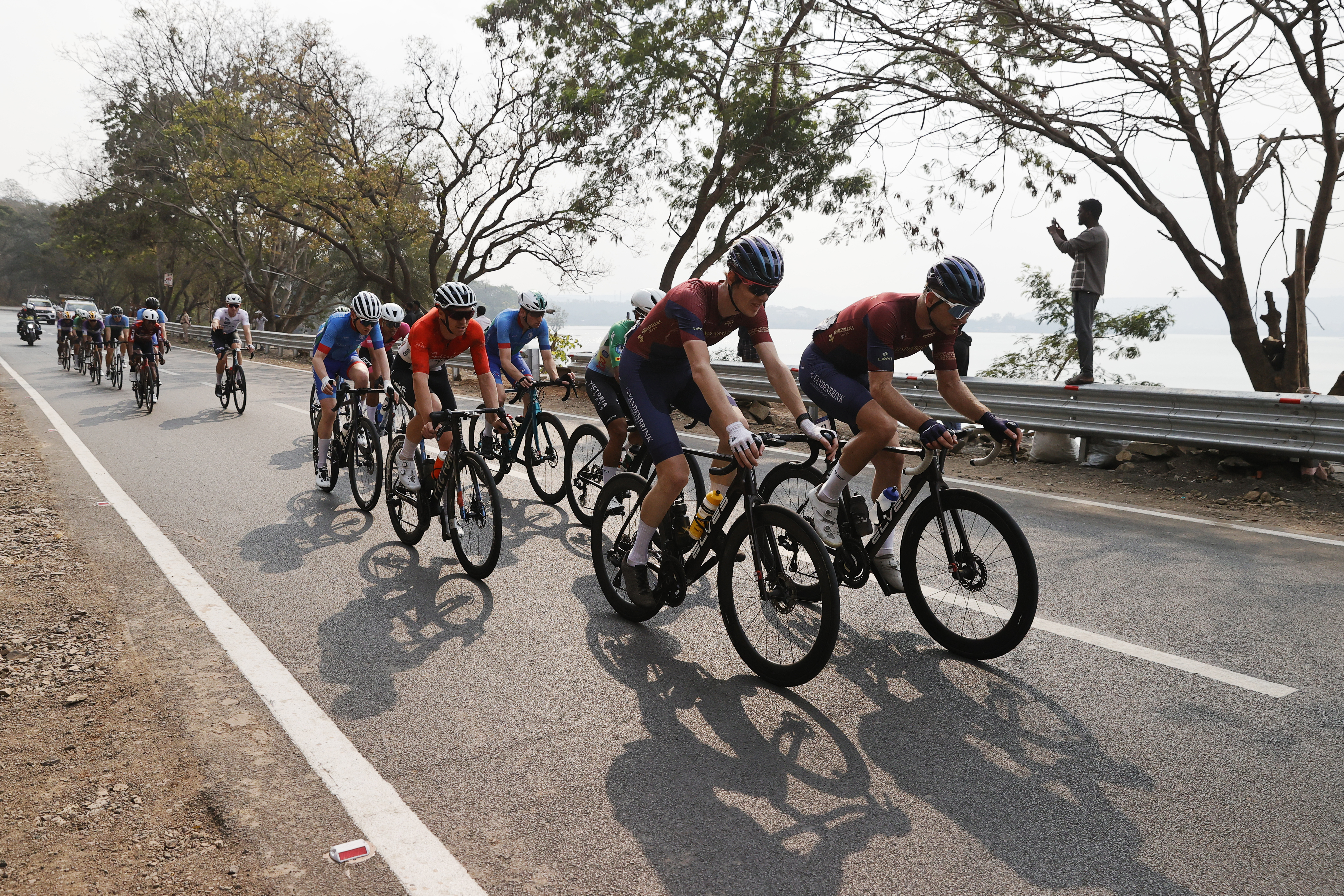 Riders zoom past the country side during stage two of the Bajaj Pune Grand Tour 2026 held in the City of Pune on the 21st January 2026.  The Pune Grand Tour marks India’s first entry into the global professional cycling calendar.   Owing to its UCI classification the PGT2026 will offer riders the opportunity to earn valuable ranking points that count toward qualification for the LA 2028 Summer Olympics.Photo by s Saikat Das /Sportzpics / PGT 2026