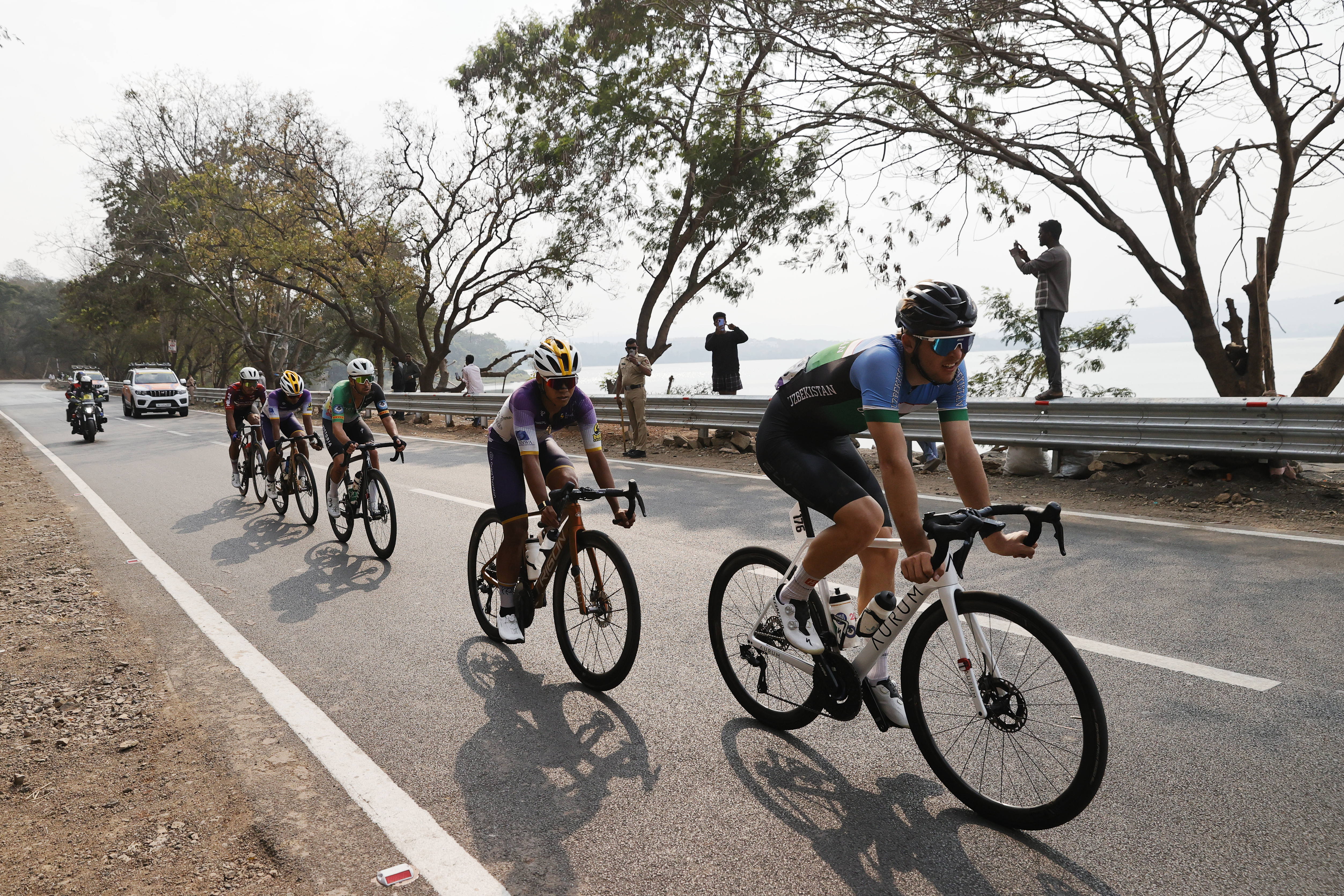 Riders zoom past the country side during stage two of the Bajaj Pune Grand Tour 2026 held in the City of Pune on the 21st January 2026.  The Pune Grand Tour marks India’s first entry into the global professional cycling calendar.   Owing to its UCI classification the PGT2026 will offer riders the opportunity to earn valuable ranking points that count toward qualification for the LA 2028 Summer Olympics.Photo by s Saikat Das /Sportzpics / PGT 2026