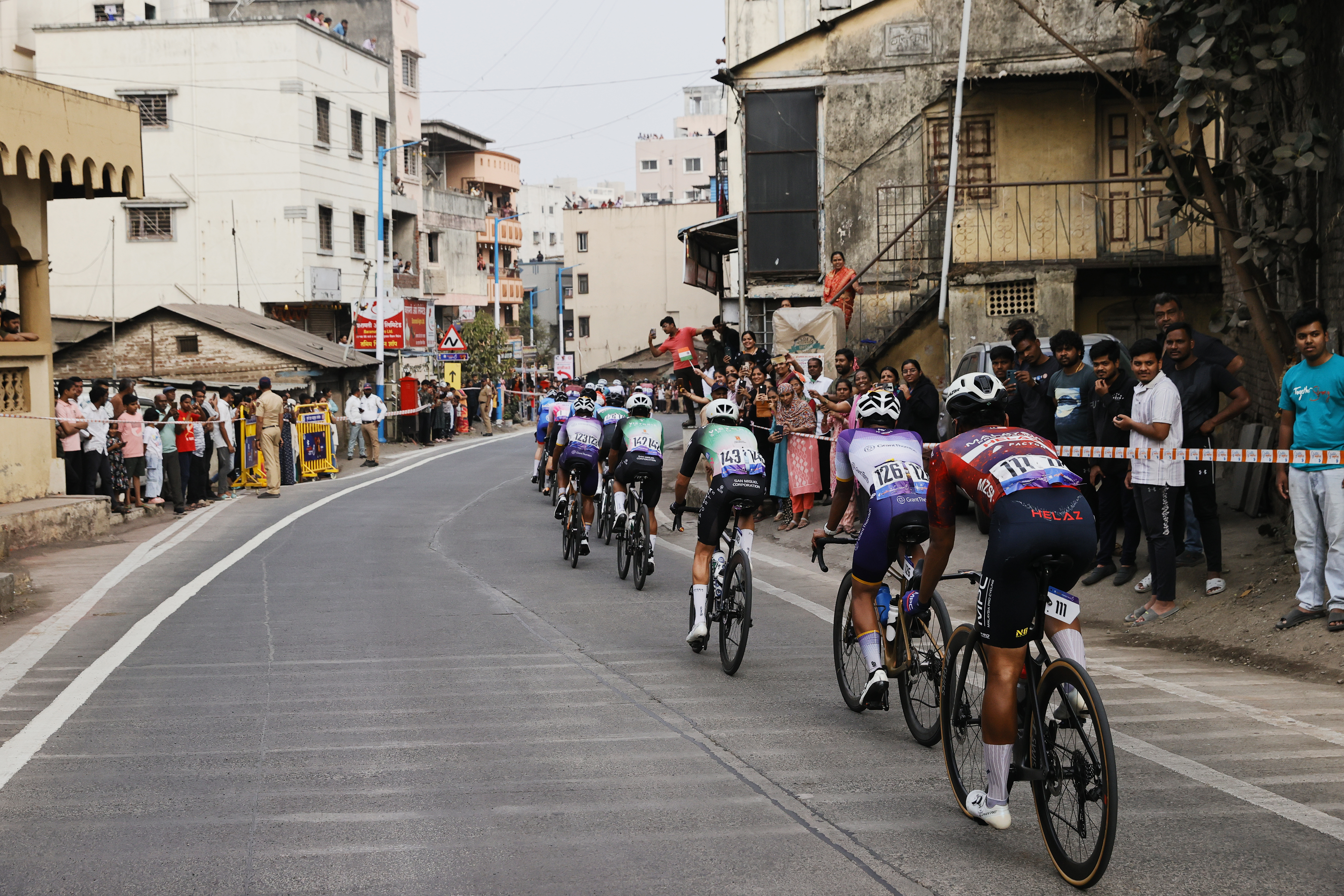 Riders zoom past the country side during stage two of the Bajaj Pune Grand Tour 2026 held in the City of Pune on the 21st January 2026.  The Pune Grand Tour marks India’s first entry into the global professional cycling calendar.   Owing to its UCI classification the PGT2026 will offer riders the opportunity to earn valuable ranking points that count toward qualification for the LA 2028 Summer Olympics.Photo by s Saikat Das /Sportzpics / PGT 2026