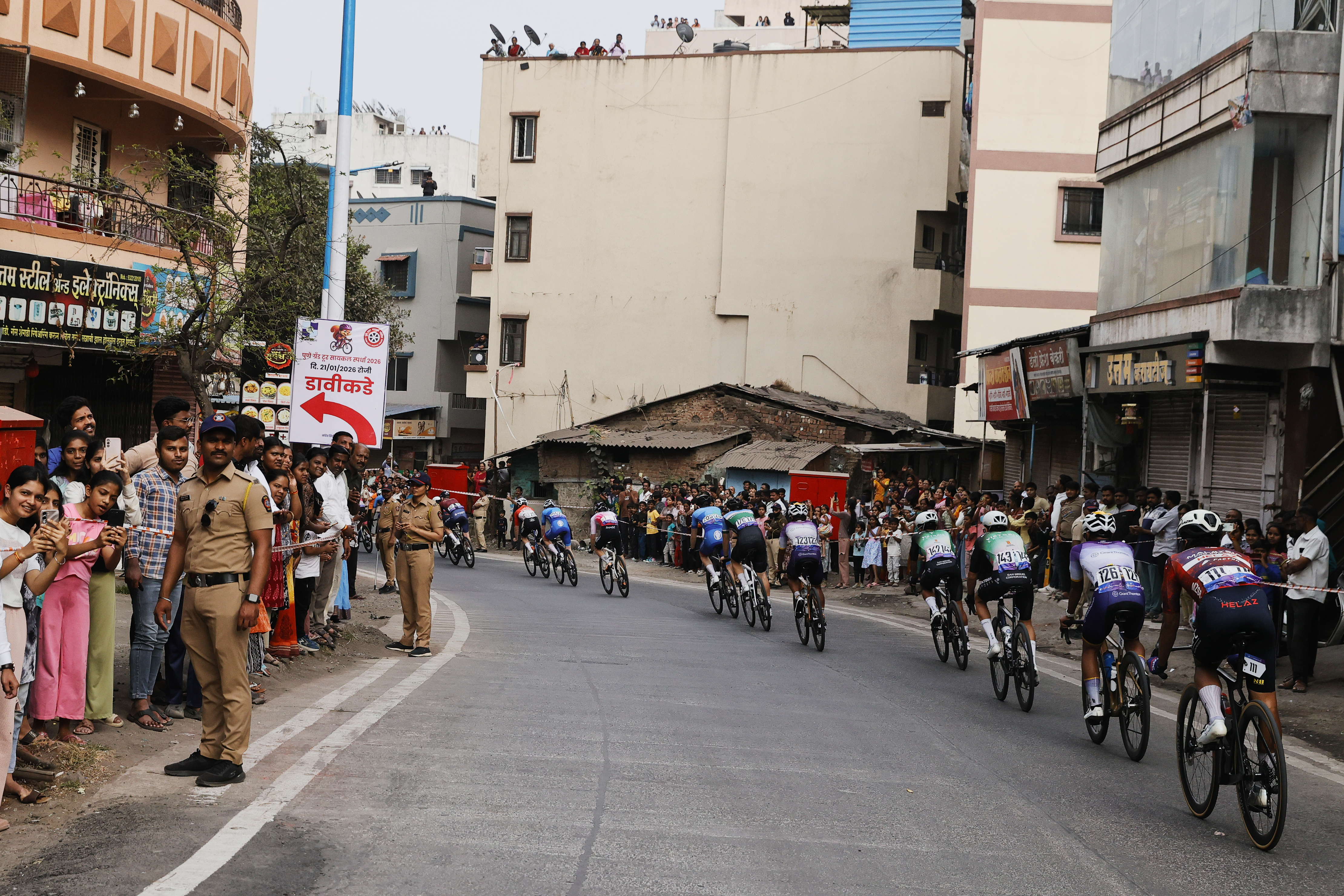Riders zoom past the country side during stage two of the Bajaj Pune Grand Tour 2026 held in the City of Pune on the 21st January 2026.  The Pune Grand Tour marks India’s first entry into the global professional cycling calendar.   Owing to its UCI classification the PGT2026 will offer riders the opportunity to earn valuable ranking points that count toward qualification for the LA 2028 Summer Olympics.Photo by s Saikat Das /Sportzpics / PGT 2026