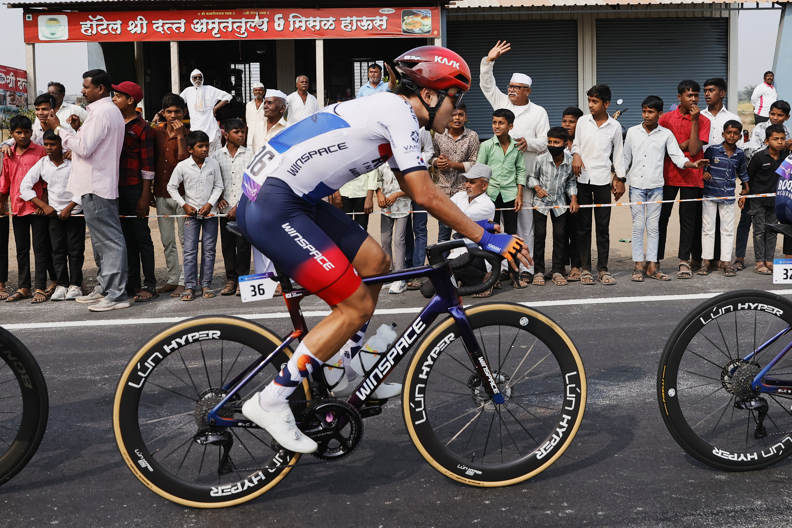 Riders zoom past the country side during stage three of the Bajaj Pune Grand Tour 2026 held in the City of Pune on the 22nd January 2026.  The Pune Grand Tour marks India’s first entry into the global professional cycling calendar.   Owing to its UCI classification the PGT2026 will offer riders the opportunity to earn valuable ranking points that count toward qualification for the LA 2028 Summer Olympics.Photo by Saikat Das /Sportzpics / PGT 2026