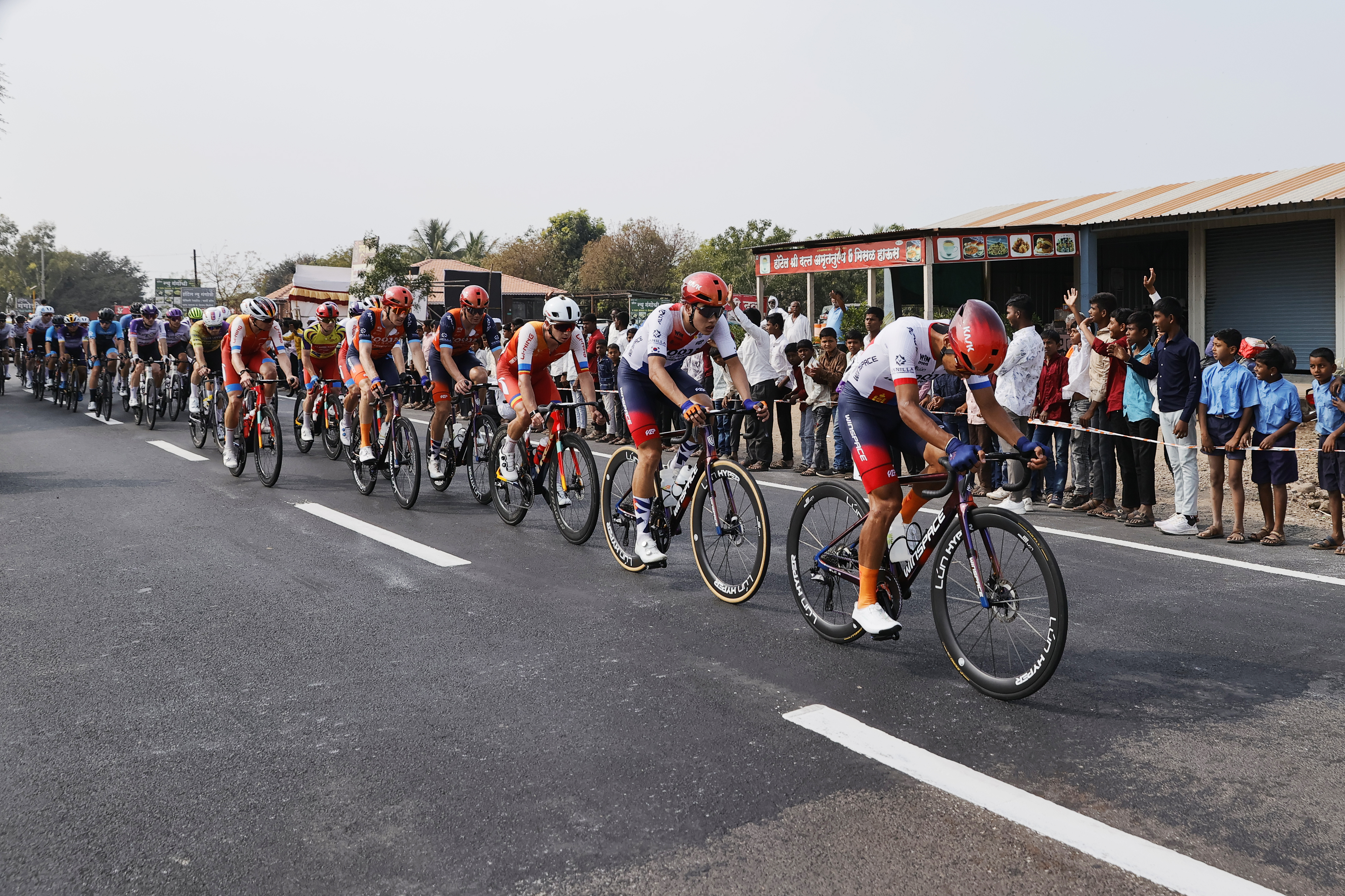Riders zoom past the country side during stage three of the Bajaj Pune Grand Tour 2026 held in the City of Pune on the 22nd January 2026.  The Pune Grand Tour marks India’s first entry into the global professional cycling calendar.   Owing to its UCI classification the PGT2026 will offer riders the opportunity to earn valuable ranking points that count toward qualification for the LA 2028 Summer Olympics.Photo by Saikat Das /Sportzpics / PGT 2026