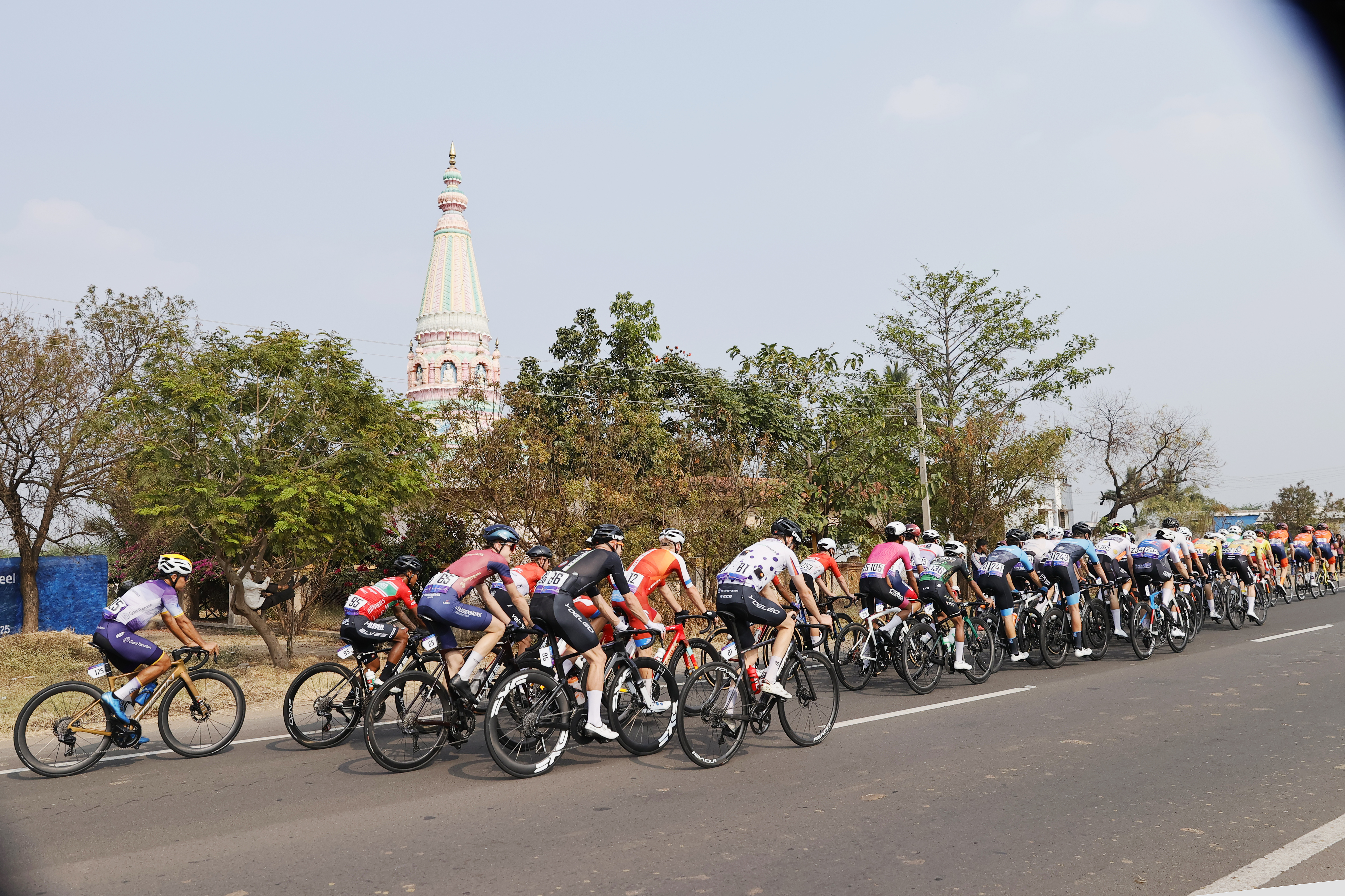 Riders zoom past the country side during stage three of the Bajaj Pune Grand Tour 2026 held in the City of Pune on the 22nd January 2026.  The Pune Grand Tour marks India’s first entry into the global professional cycling calendar.   Owing to its UCI classification the PGT2026 will offer riders the opportunity to earn valuable ranking points that count toward qualification for the LA 2028 Summer Olympics.Photo by Saikat Das /Sportzpics / PGT 2026