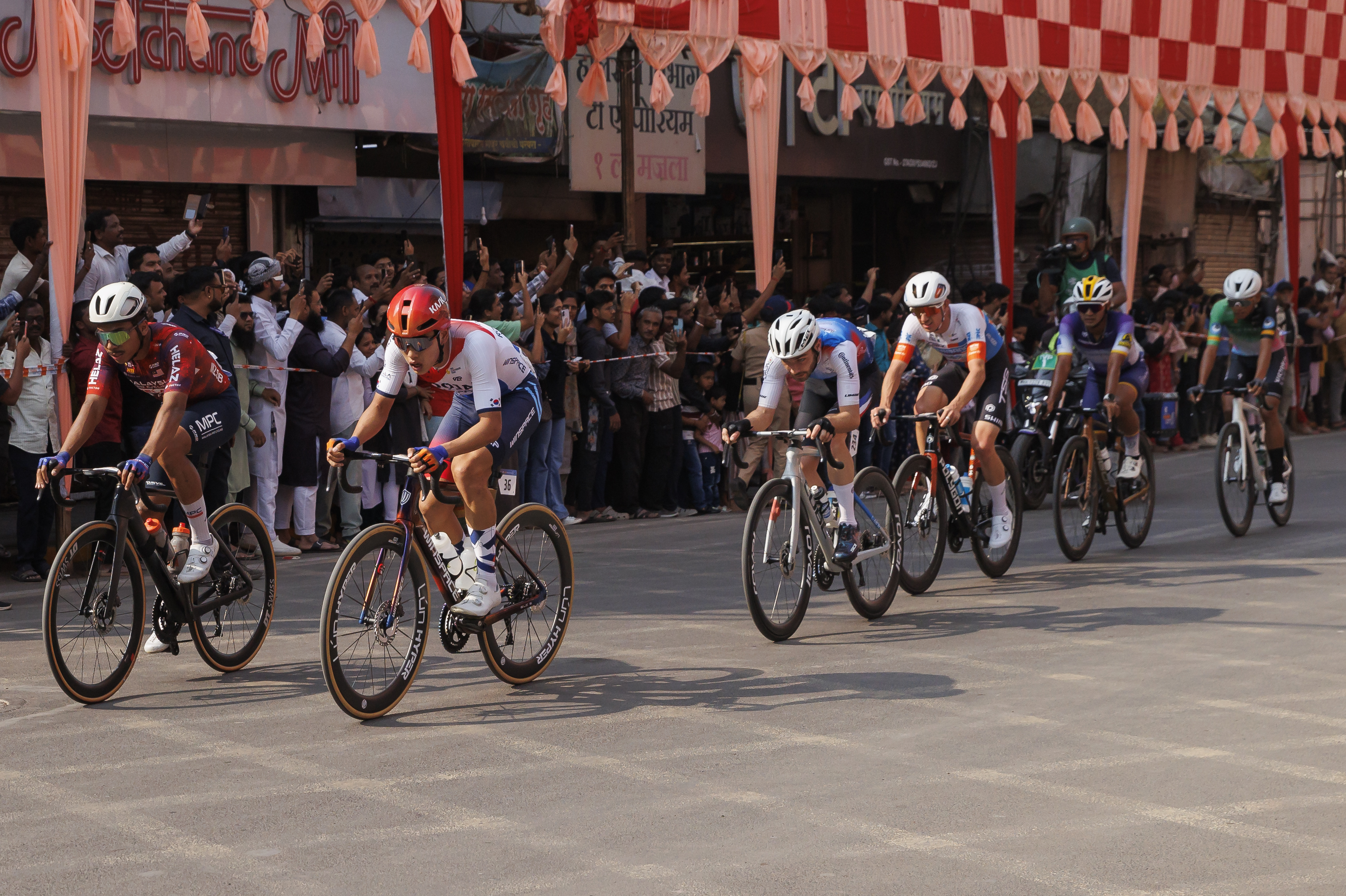 Cyclist zooming past the city during stage four of the Bajaj Pune Grand Tour 2026 held in the City of Pune on the 23rd January 2026.  The Pune Grand Tour marks India’s first entry into the global professional cycling calendar.   Owing to its UCI classification the PGT2026 will offer riders the opportunity to earn valuable ranking points that count toward qualification for the LA 2028 Summer Olympics.Photo by: s Saikat Das / Sportzpics / PGT 2026
