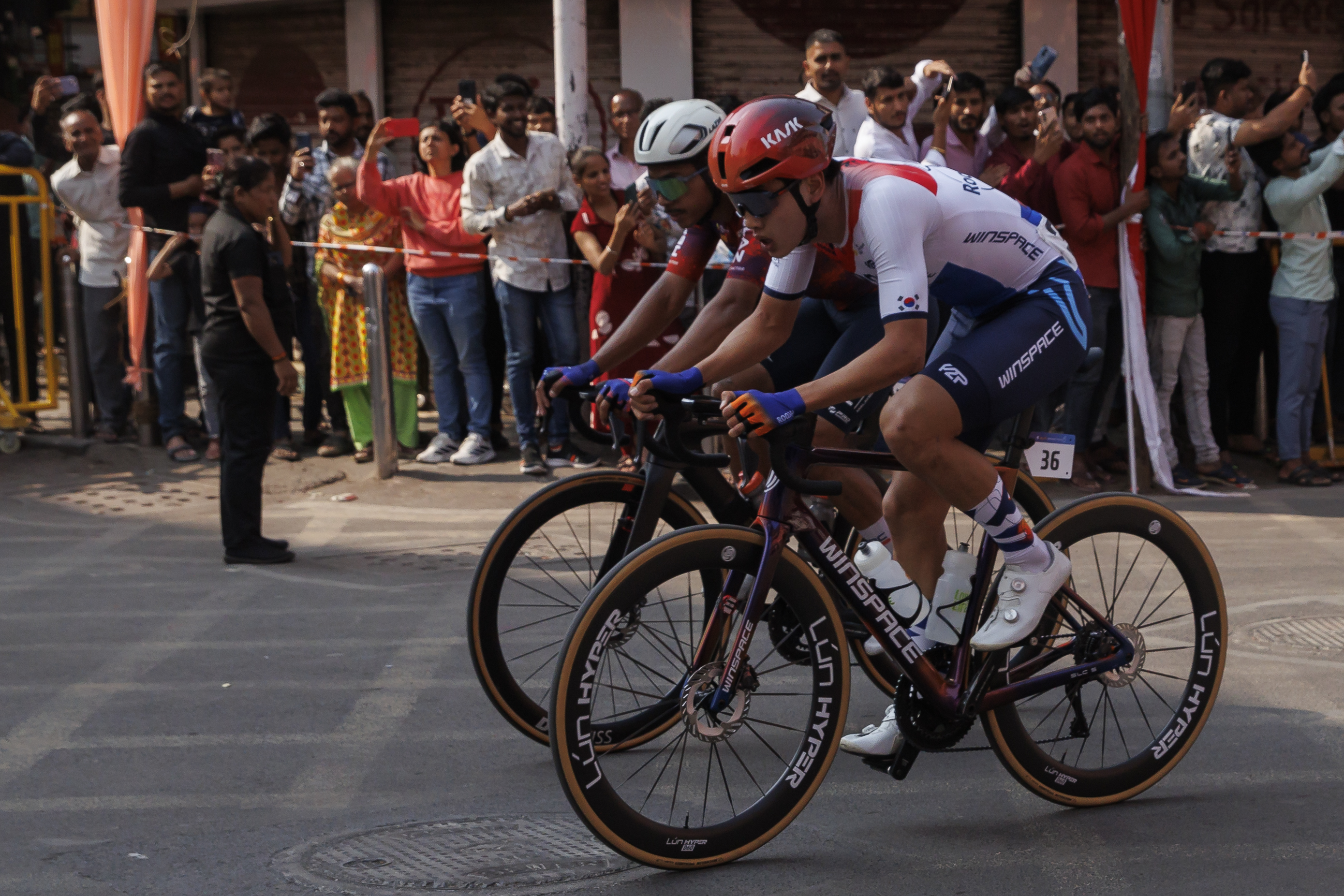 Cyclist zooming past the city during stage four of the Bajaj Pune Grand Tour 2026 held in the City of Pune on the 23rd January 2026.  The Pune Grand Tour marks India’s first entry into the global professional cycling calendar.   Owing to its UCI classification the PGT2026 will offer riders the opportunity to earn valuable ranking points that count toward qualification for the LA 2028 Summer Olympics.Photo by: s Saikat Das / Sportzpics / PGT 2026